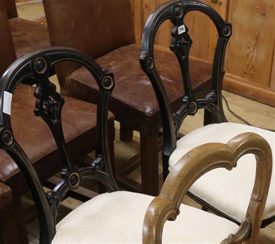 A pair of ebonised dining chairs